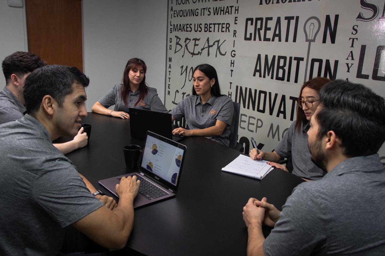 Team meeting around the conference table at MM Online